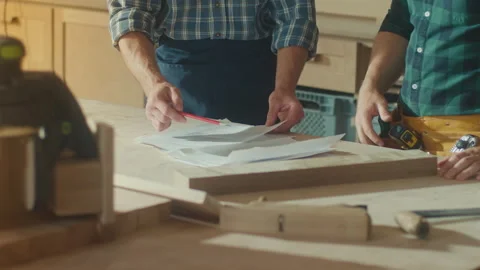 Hands of Carpenter Using a Tape Measure Ruler to Measuring Wood Board Stock Footage 224171565