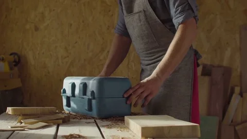 Hands of carpenter woodworker opening tool box on the table in workshop Stock Footage 76098445