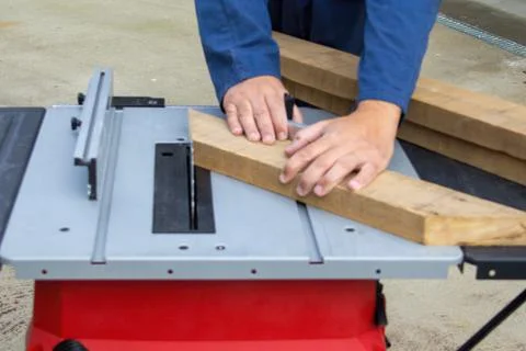 Hands of carpenter at work while cutting wood Stock Photos