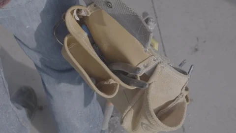 Hands carry a tool belt while walking Stock Footage 102125008