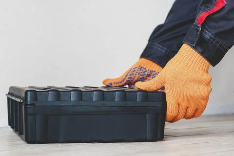 Hands with a case. gloves, tool box, person Stock Photos