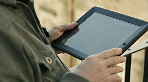 Hands of casual man holding digital tablet, outdoor Stock-Footage 34277986