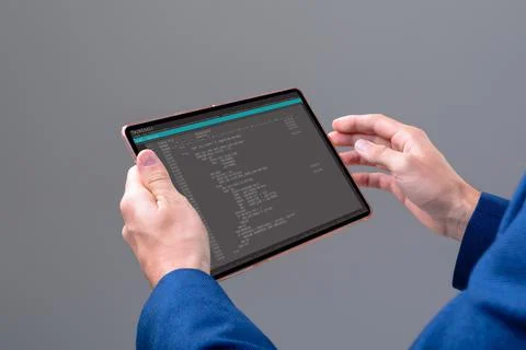 Hands of caucasian male programmer using tablet with coding on screen Stock-Fotos