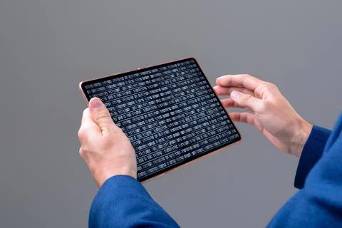 Hands of caucasian male programmer using tablet with coding on screen Stock-Fotos