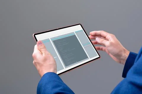 Hands of caucasian male programmer using tablet with coding on screen Stock-Fotos