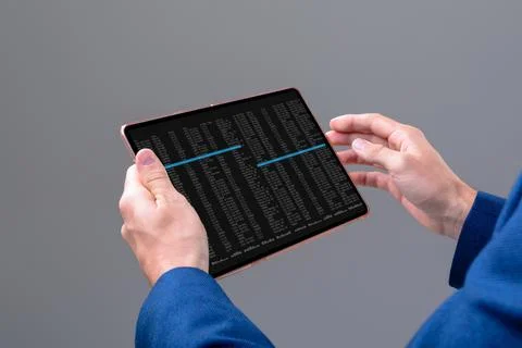 Hands of caucasian male programmer using tablet with coding on screen Stock-Fotos