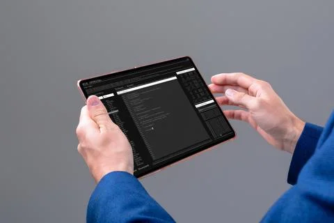 Hands of caucasian male programmer using tablet with coding on screen Stock Photos