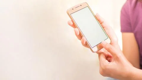 Hands with a cellphone with an empty screen. Close up picture of a cellphone. Stock Photos