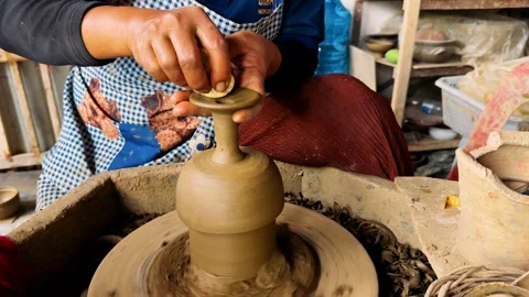 Hands of a ceramic factory worker making a vase out of clay. An expert potter, h Stock Footage 307519327