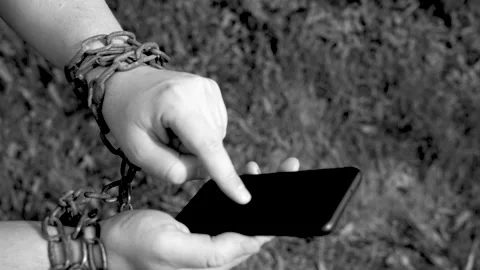 Hands in chains hold a smartphone Stock Footage 134468220