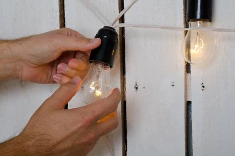 Hands changing light bulb Stock Photos