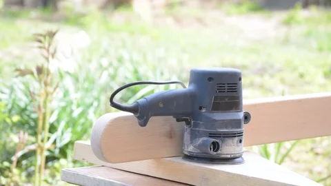 Hands changing sand paper on random orbital sander and grinding Stock Footage 87857427