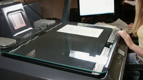Hands changing a sheet of manuscript paper into a scanning device Stock-Footage 70672589