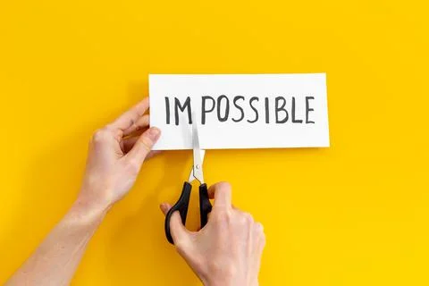 Hands changing word impossible to possible with scissors. Selfmade concept Foto stock