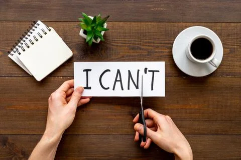 Hands changing words I cannot to I can with scissors. Selfmade concept Stock Photos