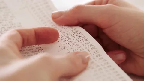 Hands checking grocery receipt or bill after grocery shopping at a supermarket. Stock Footage 143781643