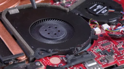 Hands checking work of propellers of cooler system of laptop during maintenance Stock Footage 131852451