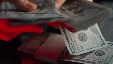 Hands checks US Dollar bills or counting in cash against the backdrop of police Stock Footage 171982306