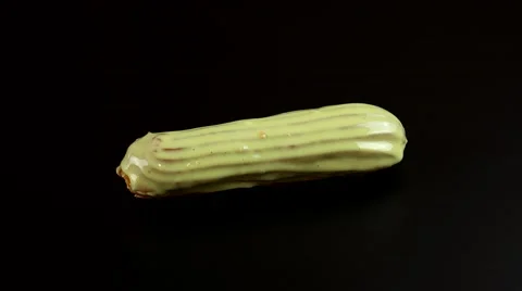 Hands of chef applying decoration to the Eclairs dessert Stock Footage 63853223