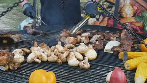 Hands of the chef cook meat and vegetables on the grill. Stock Footage 118461306