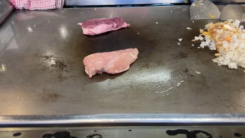 Hands of chef cooking duck chicken and egg fried rice on griddle Видео 249094944