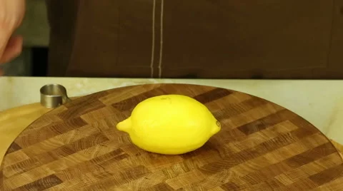 Hands chef cut the lemon into two parts Stock Footage 61879743