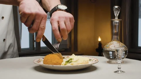 Hands of a chef cutting fried cutlet Stock Footage 148018748