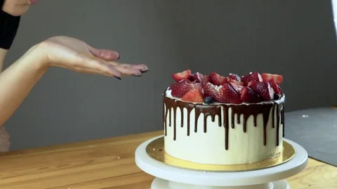 Hands of chef decorating strawberry on cake Stock Footage 74804117