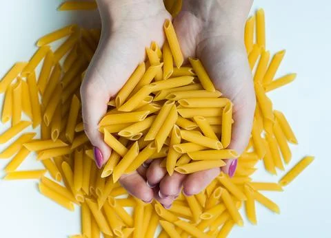 The hands of the chef holding in his hands Italian pasta Stock Photos