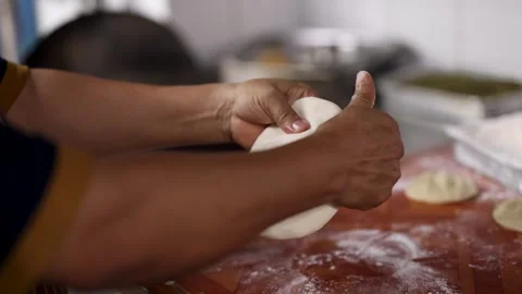 Hands of Chef Kneading and Shaping Dough for Traditional Roti Flatbread Stock Footage 345710274