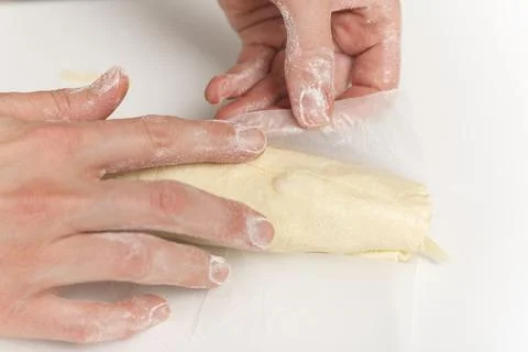 Hands of chef prepares an apple roll. Process of making a dessert. Stock-Fotos