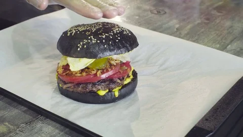 Hands of chef pressing on a ready burger Stock Footage 80143910