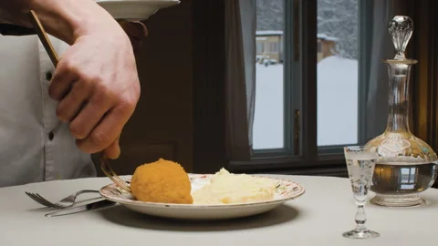 Hands of a chef putting fried cutlet on the plate Stock Footage 148023656