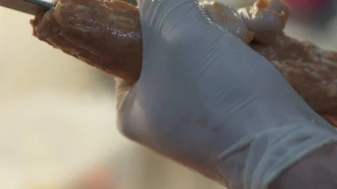Hands of chef in white rubber gloves making kebab close up. Cook forming shape Stock Footage 103617956
