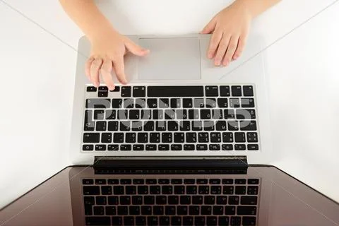 Hands of child on the notebook Stock Photos
