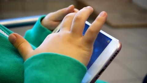 Hands of a child with a phone Stock Footage 107621654