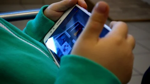 Hands of a child with a phone Stock Footage 107621784