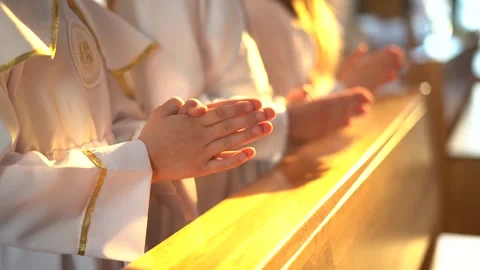 Hands of children folded in prayer during the First Holy Communion Stock Footage 154911844