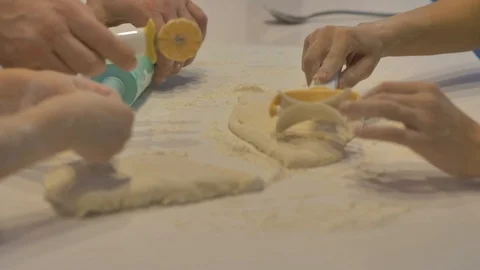 Hands of children make figures from the dough, on a white table, close-up Video stock 127429262