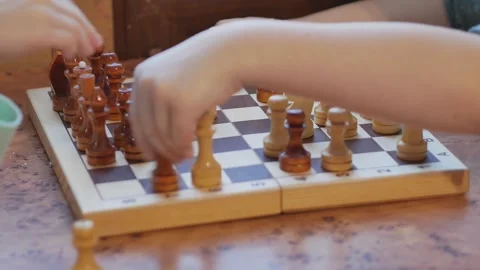 The hands of children playing a chess game, board games developing intelligence. Stockbeeldmateriaal 254361324