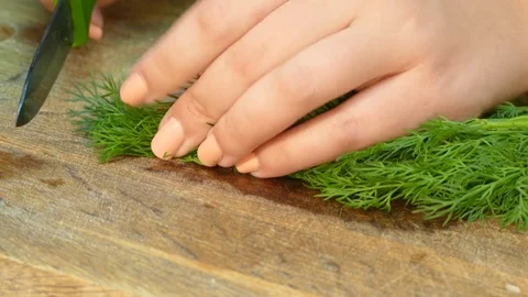 Hands chopped on a kitchen board dill Stock Footage 78243145