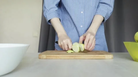 Hands chopping apple with kitchen knife, close up of food preparation, fres.. Stock Footage 315517531