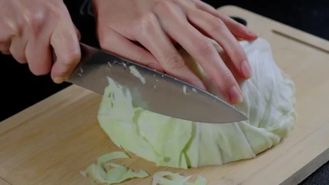 Hands Chopping Cabbage on Cutting Board in Cooking Stock-Footage 341430827