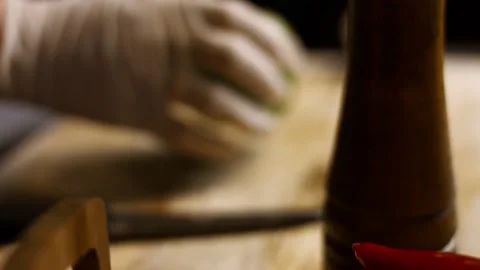 Hands chopping green fresh pepper on a cutting board then throws peppers with a Stock Footage 156449280