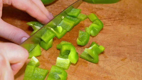 Hands chopping green fresh pepper on a cutting board Stock Footage 247833230