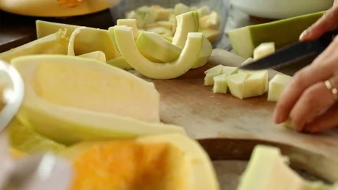 Hands chopping pumpkin slices on cutting board Video stock 81079849