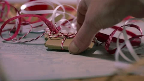 Hands with Christmas gift wrapped in string Vídeo Stock 335103626