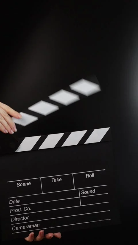 Hands with clapper board, cueing the action, movie production in progress. Stock Footage 276694497