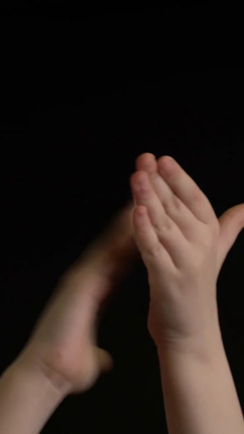 Hands clapping in applause against a black background, expressing celebration Stock Footage 347031381
