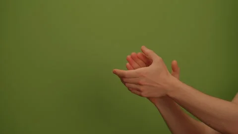 Hands clapping energetically against a vibrant green background, creating a Stock Footage 292839930
